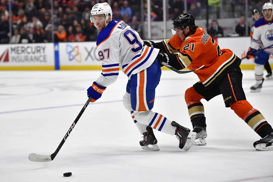 Edmonton Oilers center Connor McDavid (97) moves the puck against Anaheim Ducks center Isac Lundestrom (21) during the first period at Honda Center, Anaheim, Calif., on April 5, 2023. (Gary A. Vasquez-USA TODAY Sports via Field Level Media)