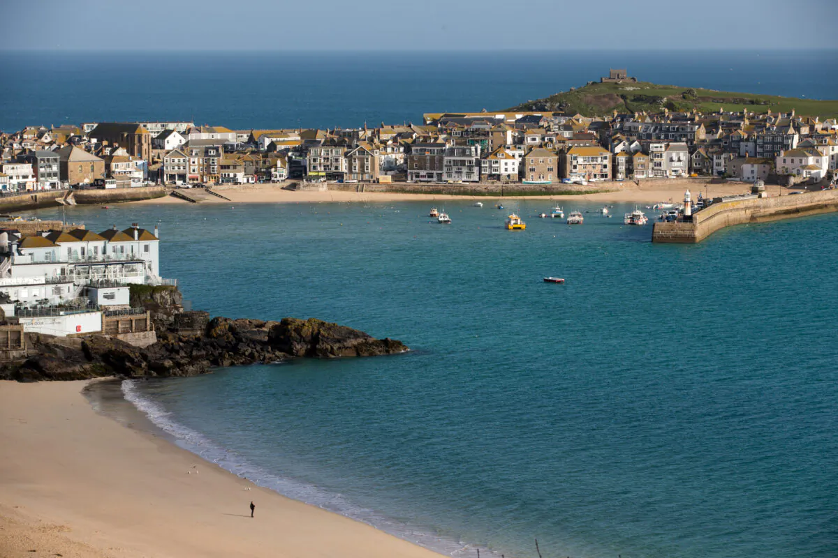 The morning sun illuminates properties in the popular seaside resort of St Ives, in Cornwall, England on April 14, 2016. (Photo by Matt Cardy/Getty Images)