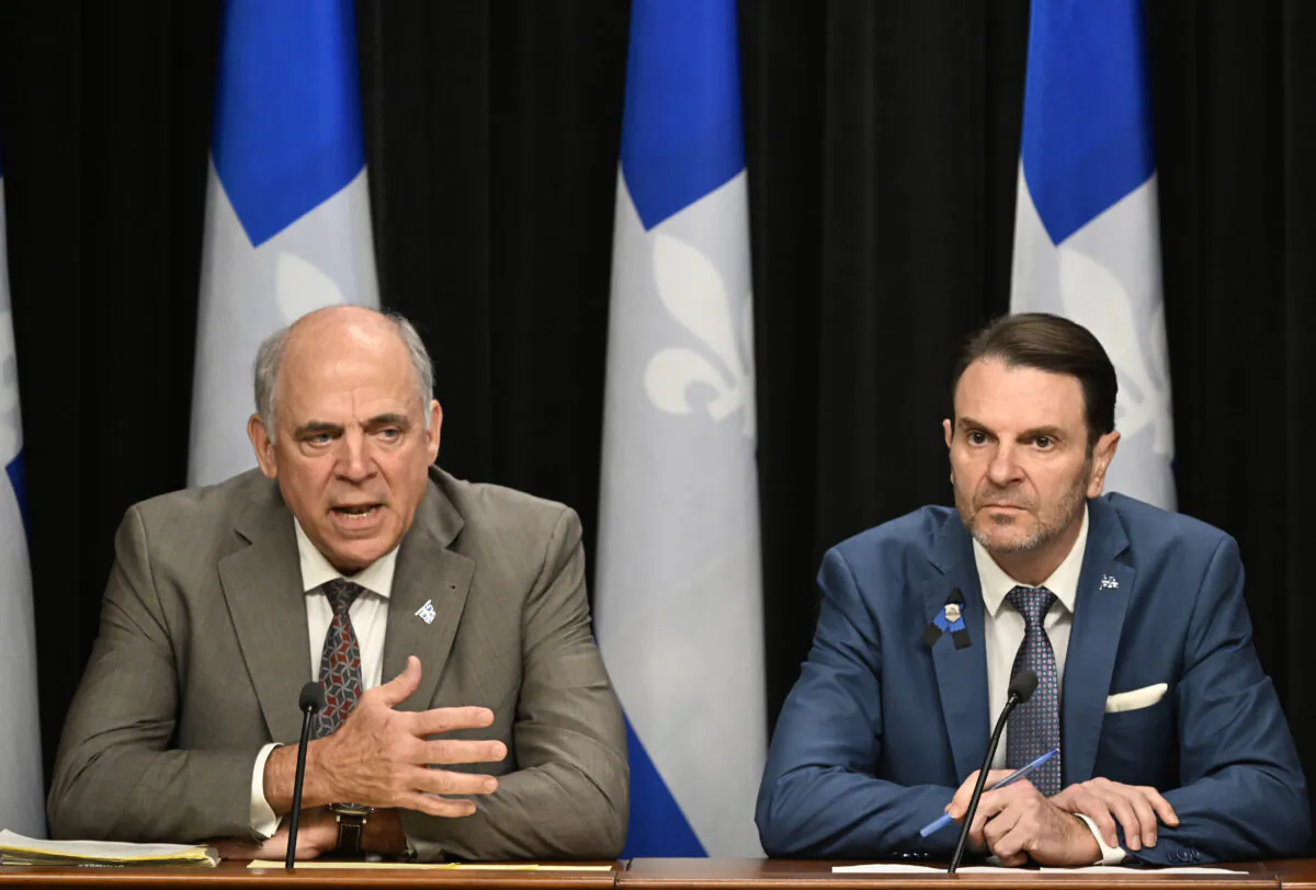 Quebec Economy and Innovation Minister Pierre Fitzgibbon and Quebec Public Security Minister Francois Bonnardel, right, give an update on the major ice storm that hit the Outaouais and Montreal regions, at the legislature in Quebec City on April 6, 2023. (Jacques Boissinot/The Canadian Press)