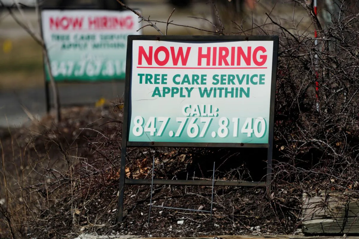 A hiring sign for tree care service work is posted in Wheeling, Ill., on March 19, 2023. (Nam Y. Huh/AP Photo)