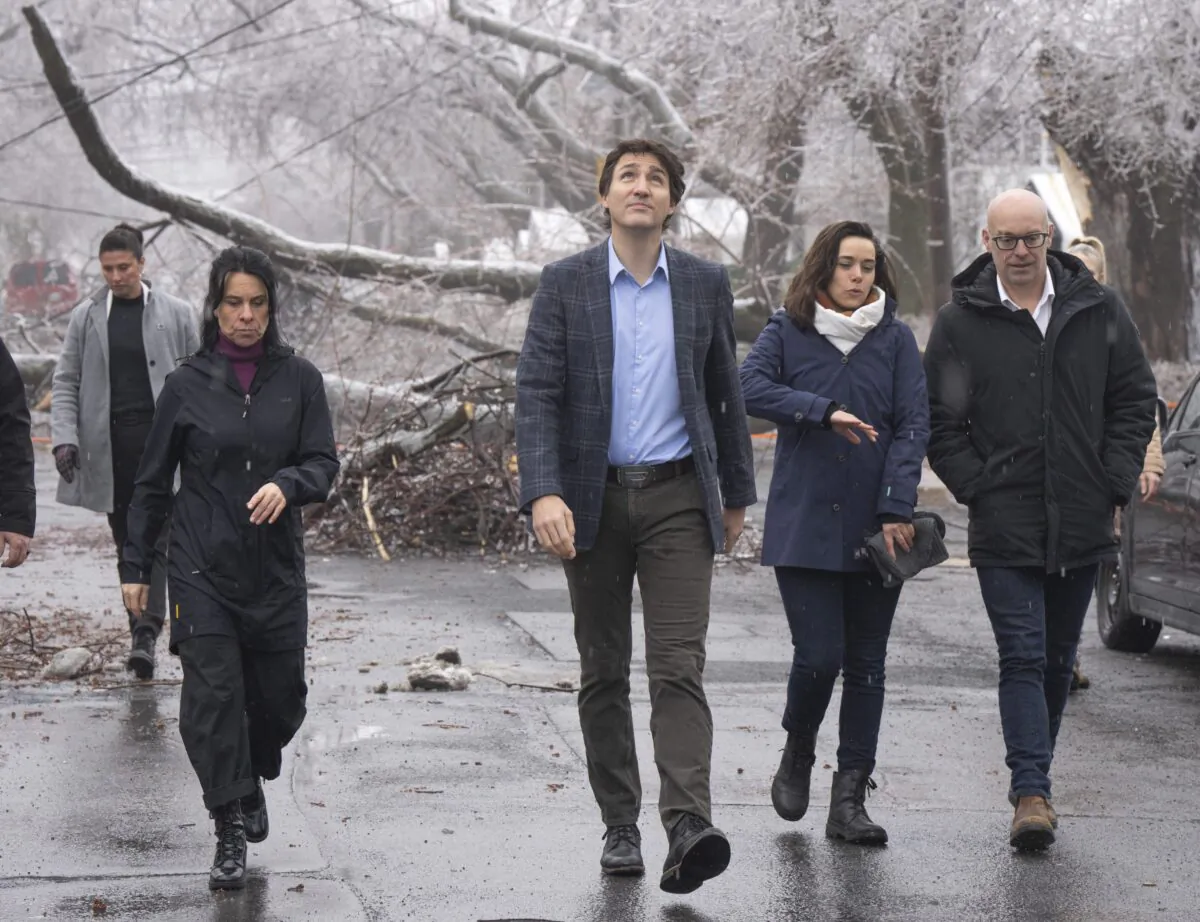 Prime Minister Justin Trudeau watches for falling ice as he surveys the damage with Mayor Valérie Plante after yesterday’s ice storm, which left over a million customers without power, in Montreal, April 6, 2023. (Ryan Remiorz/The Canadian Press)