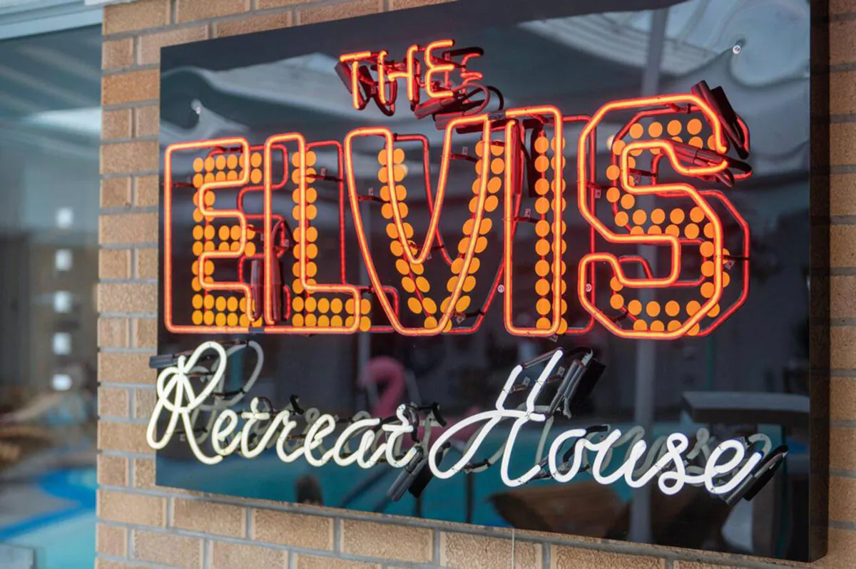 A neon sign over the bar, near the guitar-shaped swimming pool, lets guests know exactly where they are. (Emily Curiel/The Kansas City Star/TNS)