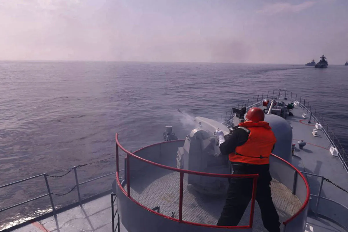 A handout picture made available by the Iranian Army official website on January, 21 2022 shows an navy-man firing atop a warship during a joint military drill in the Indian ocean. - Iran, Russia and China will began today joint naval drills for three days in the Indian Ocean, seeking to reinforce "common security", an Iranian naval official said. (Photo by Iranian Army office / AFP) (Photo by -/Iranian Army office/AFP via Getty Images)