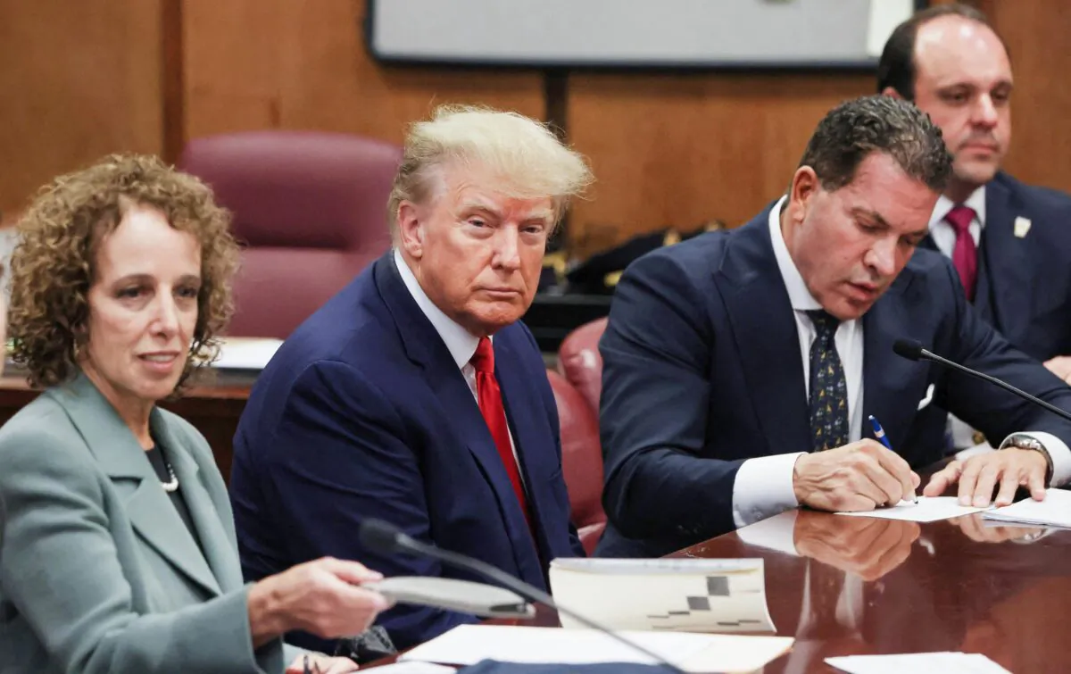 Former U.S. President Donald Trump is accompanied by members of his legal team, Susan Necheles and Joe Tacopina, as he appears in court for an arraignment on charges stemming from his indictment by a Manhattan grand jury, April 4, 2023. (REUTERS/ Andrew Kelly)