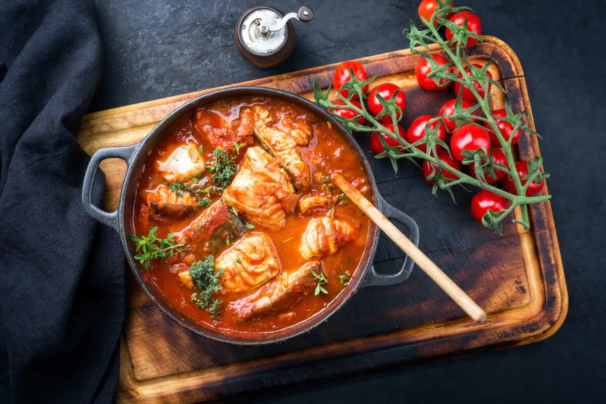 This cioppino uses grouper, scallops, and basil but you can substitute any variety of seafoods and herbs you like. (hlphoto/Shutterstock)