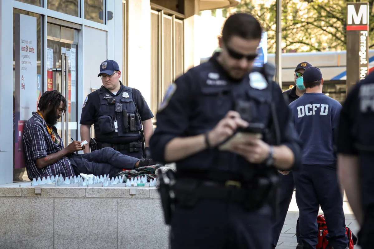 D.C. Fire and Emergency Medical Services Department and D.C. Metropolitan Police investigate a criminal offense in Washington on April 6, 2020. (Samira Bouaou/The Epoch Times)
