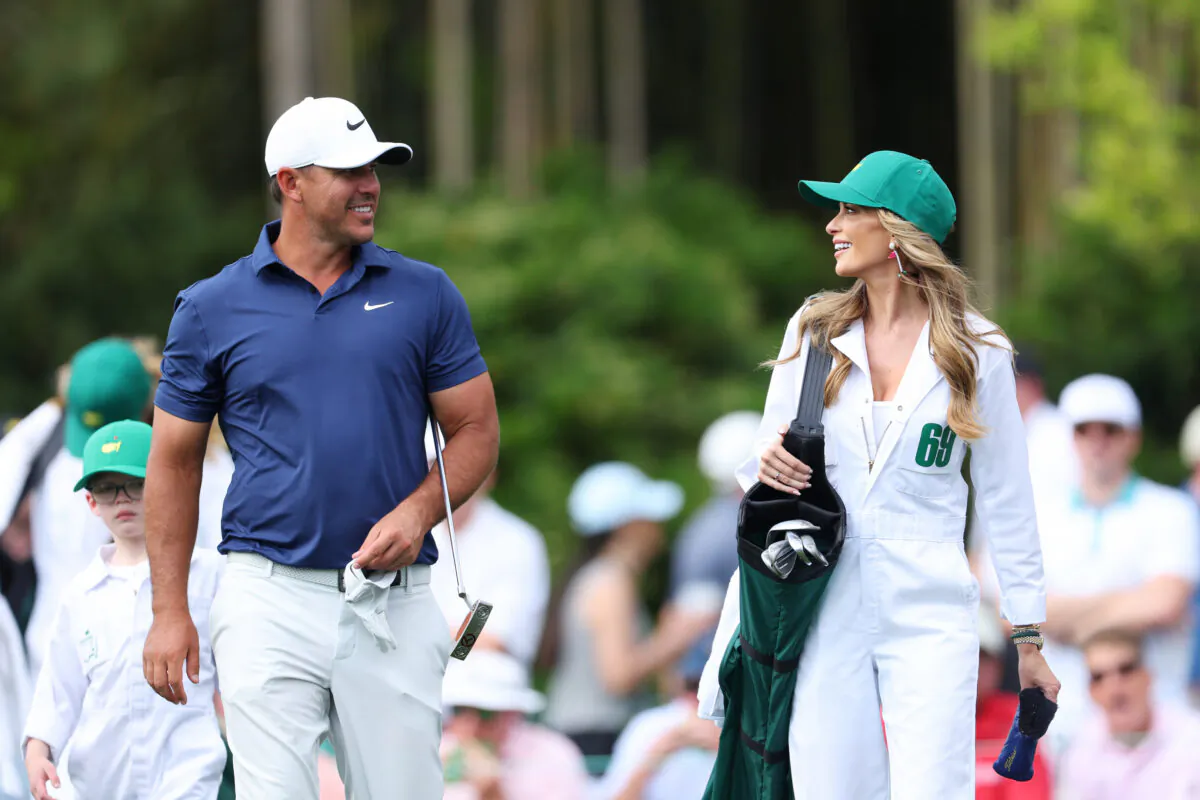 Brooks Koepka of the United States looks on with his wife, Jena Sims Koepka, during the Par 3 contest prior to the 2023 Masters Tournament at Augusta National Golf Club in Augusta, Georgia on April 5, 2023. (Andrew Redington/Getty Images)
