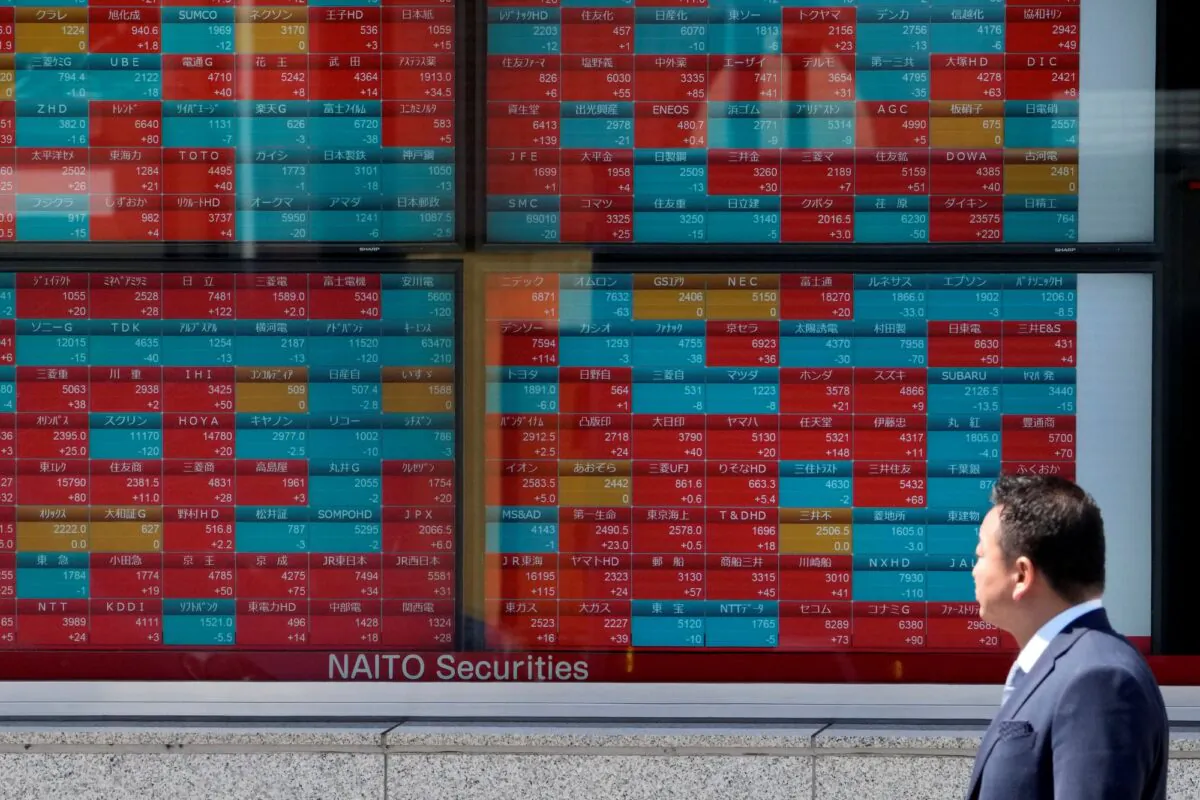 A man looks at an electronic stock board showing Japan's stock prices at a securities firm in Tokyo on April 4, 2023. (Shuji Kajiyama/AP Photo)