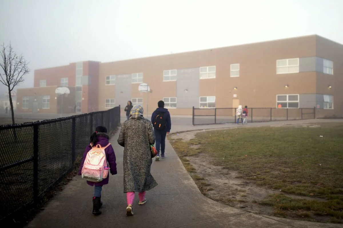 Parents walk their children to a school in Milton, Ont., on Nov. 4, 2022. (The Canadian Press/Nick Iwanyshyn)
