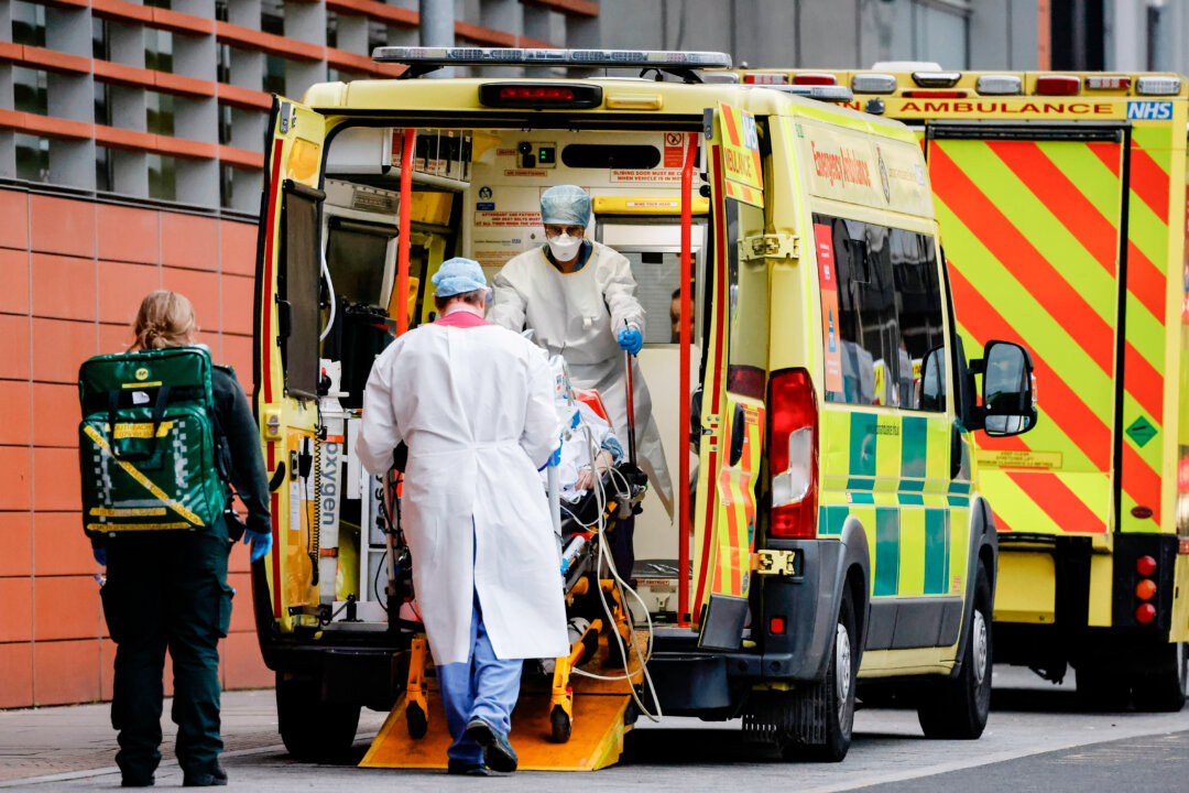 Medics take a patient from an ambulance into the Royal London hospital in London on January 19, 2021. - An estimated 12 percent of people in England had been infected with coronavirus by December last year, up from nine percent in November, according to official antibody data released Tuesday. Britain is currently gripped by its third and deadliest wave of the virus, blamed on a new strain believed to be highly infectious. Health chiefs have warned intensive care units risk being overwhelmed by the surge in cases that has already led to the country suffering record numbers of daily deaths. (Photo by Tolga Akmen / AFP) (Photo by TOLGA AKMEN/AFP via Getty Images)
