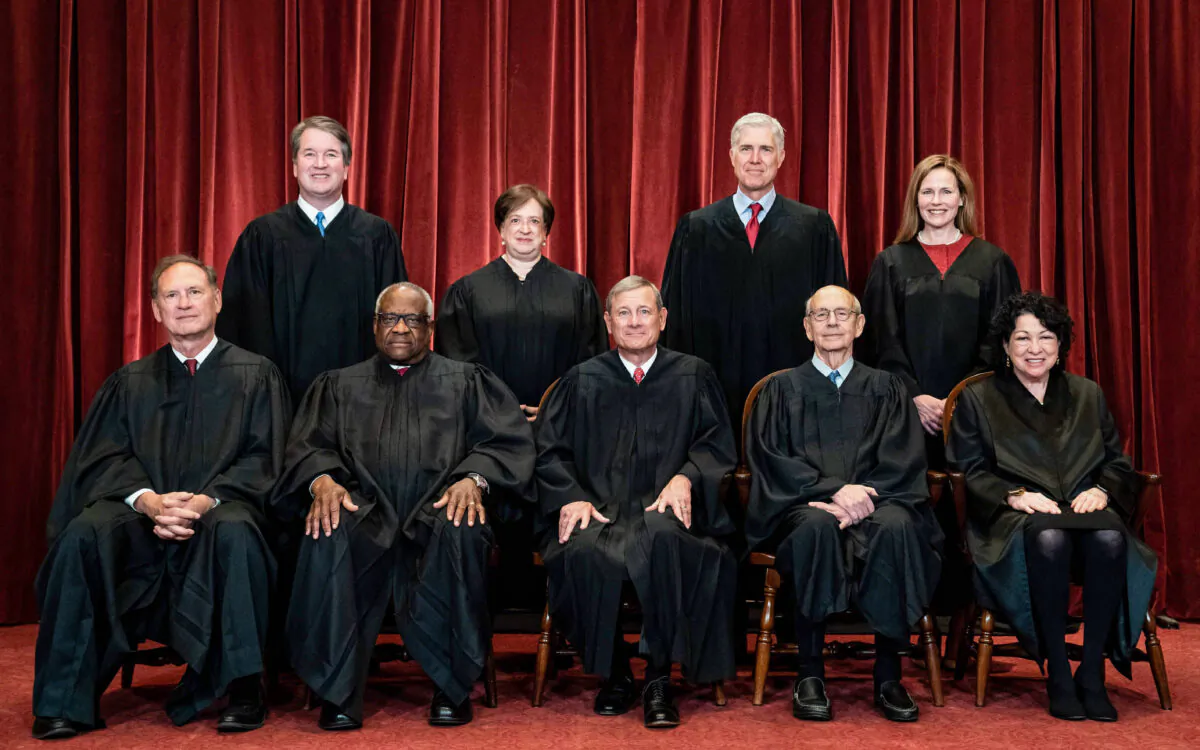 Members of the Supreme Court pose for a group photo at the Supreme Court in Washington, D.C., on April 23, 2021. Seated from left: Justices Samuel Alito and Clarence Thomas, Chief Justice John Roberts, and Justices Stephen Breyer and Sonia Sotomayor. Standing from left: Justices Brett Kavanaugh, Elena Kagan, Neil Gorsuch, and Amy Coney Barrett. (Erin Schaff/Pool/Getty Images)