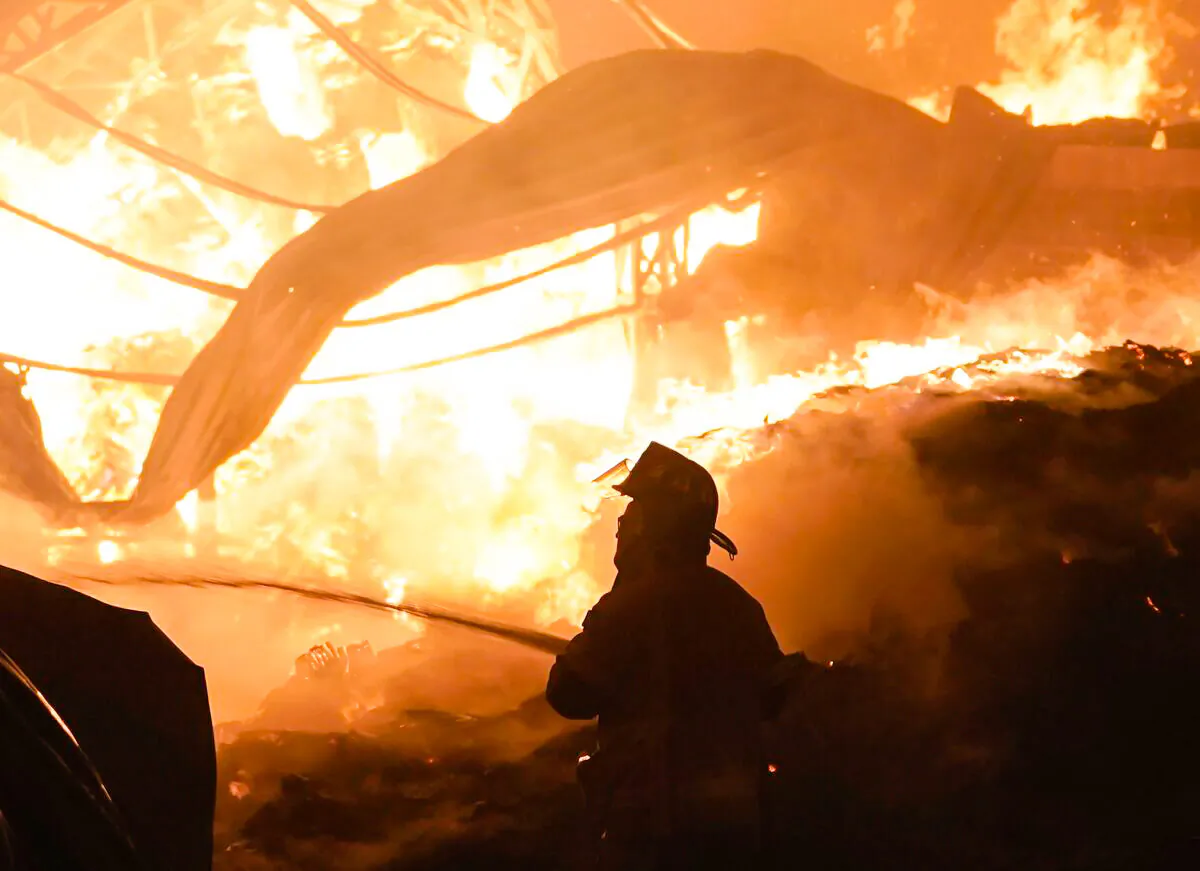 A firefighter works to extinguish a fire at the Central de Abasto wholesale market, the main food distribution center, in Mexico City on April 6, 2023. (Eduardo Verdugo/AP Photo)
