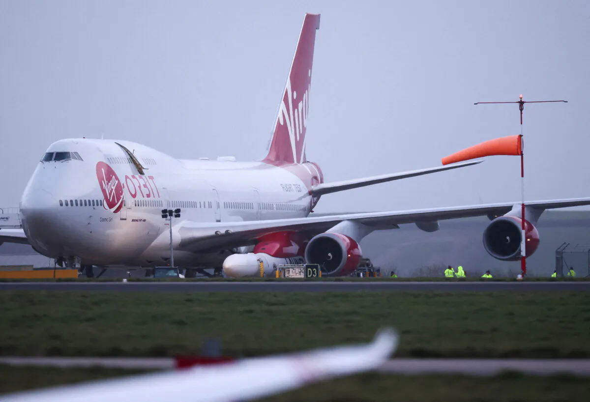 Cosmic Girl, a Virgin Boeing 747-400 aircraft sits on the tarmac with Virgin Orbit's LauncherOne rocket attached to the wing, ahead of the first UK launch, at Spaceport Cornwall at Newquay Airport in Newquay, Britain, on Jan. 9, 2023. (Henry Nicholls/Reuters)