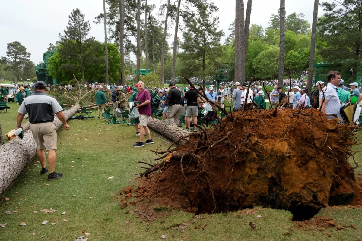 Patrons move away from two trees that blew over on the 17th hole during the second round of the Masters golf tournament at Augusta National Golf Club in Augusta, Ga.,  on April 7, 2023. (Mark Baker/AP Photo)