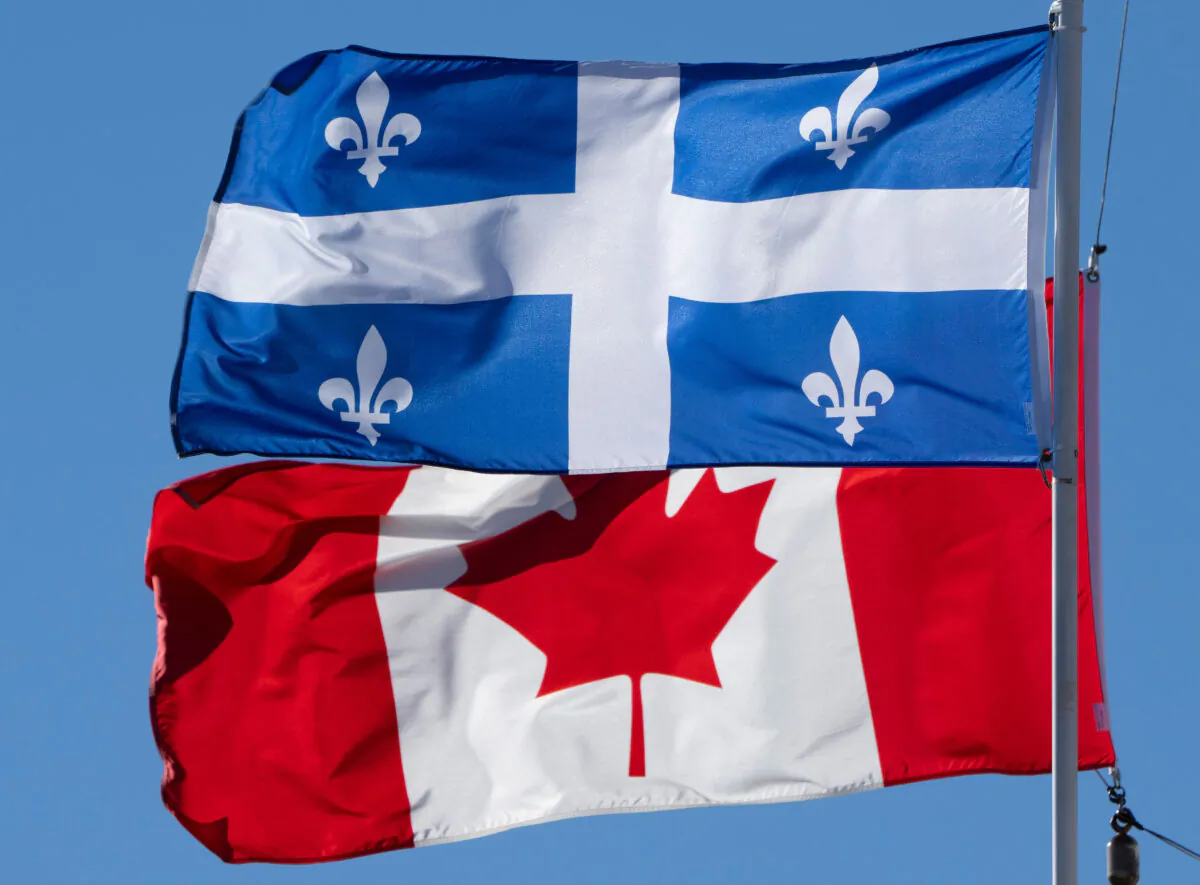 The Canadian and Quebec flags fly in Gatineau, Que., in a file photo. (The Canadian Press/Adrian Wyld)