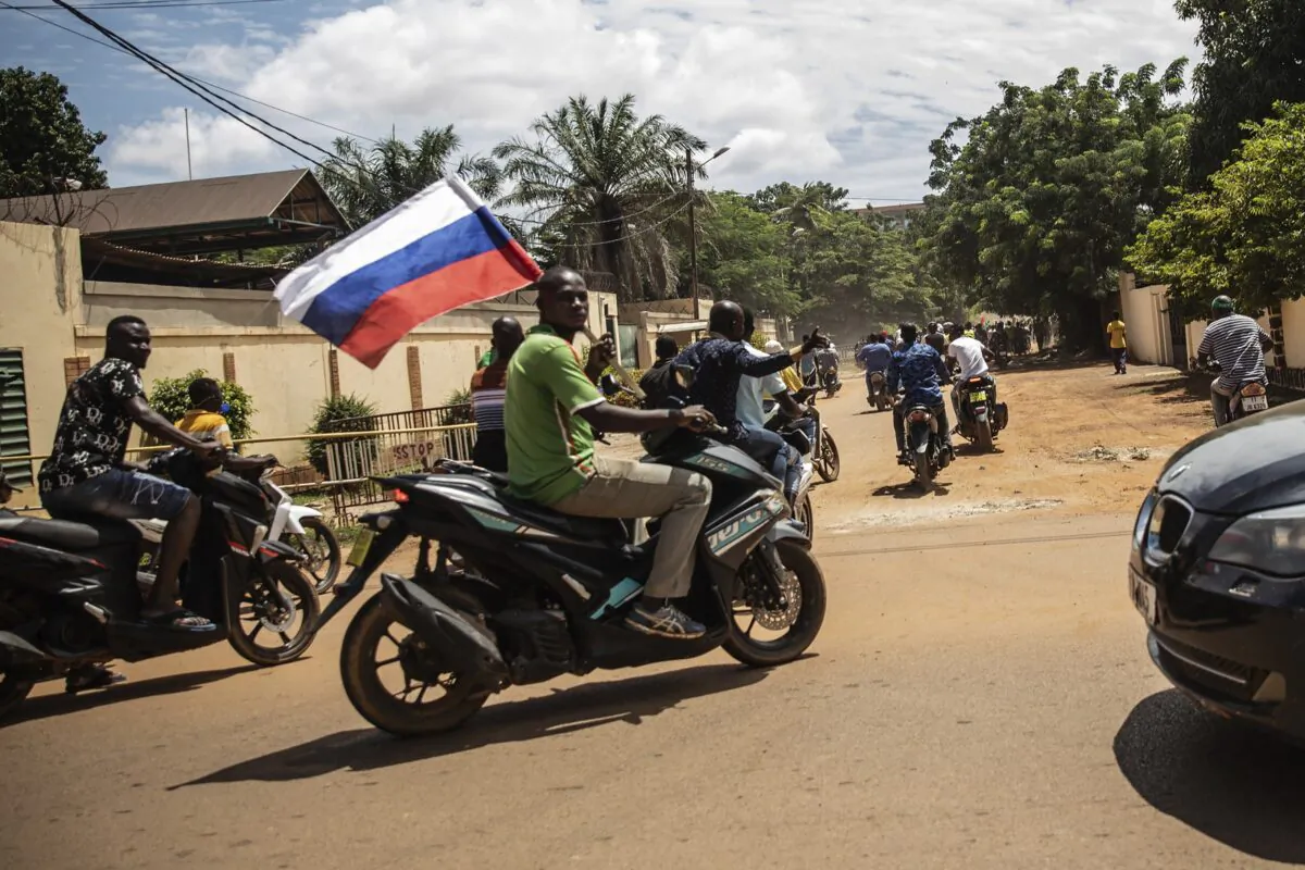 Supporters of Capt. Ibrahim Traore wave a Russian flag in the streets of Ouagadougou, Burkina Faso, on Oct. 2, 2022. (Sophie Garcia/AP Photo, File)