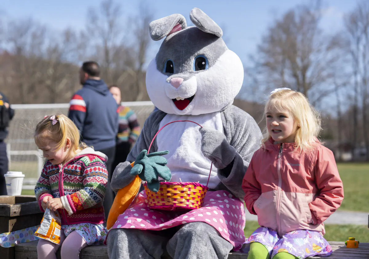 Children take photo with the Easter Bunny at the annual PBA Easter Egg hunt at Winstanley Park in Warwick, N.Y., on April 8, 2023. (Chung I Ho/The Epoch Times)