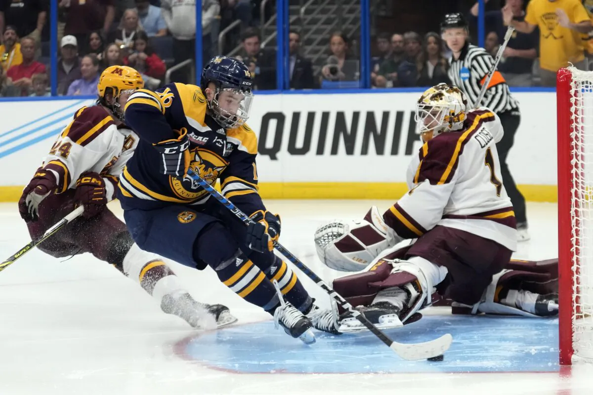 Quinnipiac forward Jacob Quillan (16) scores the game-winning goal past Minnesota goaltender Justen Close during overtime of the championship game in the Frozen Four NCAA college hockey tournament in Tampa, Fla., on April 8, 2023. (Chris O'Meara/AP Photo)