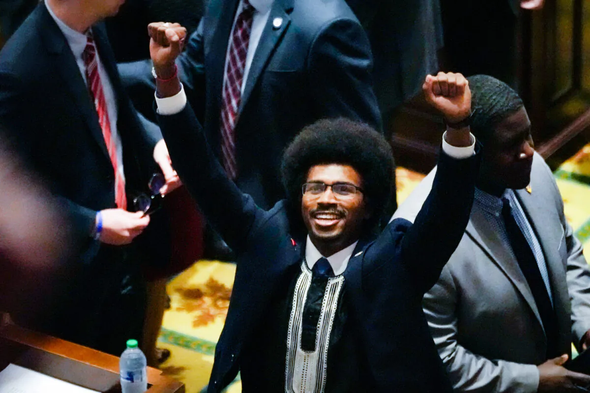 State Rep. Justin Pearson (D-Memphis) raises his fists on the floor of the House chamber to recognize his supporters before the start of the legislative session in Nashville, Tenn., on April 6, 2023. (George Walker IV/AP Photo)