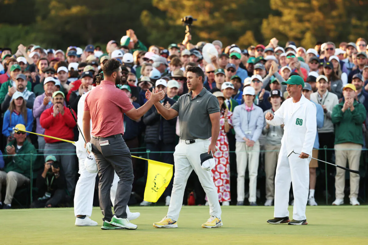 Jon Rahm of Spain shakes hands with Brooks Koepka of the United States on the 18th green after he won the 2023 Masters Tournament at Augusta National Golf Club in Augusta, Ga., on April 9, 2023. (Christian Petersen/Getty Images)
