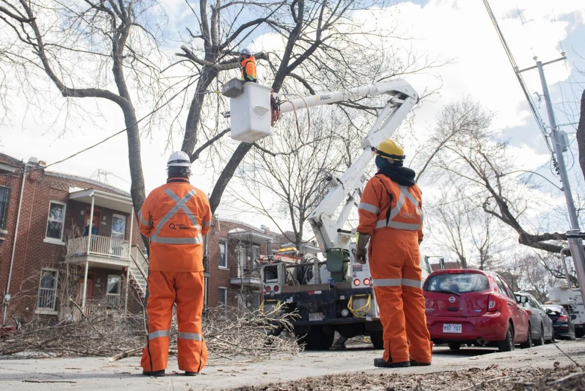 A Hydro Quebec crew works on a power line following an ice storm in Montreal, Apr. 7, 2023. (The Canadian Press/Graham Hughes)
