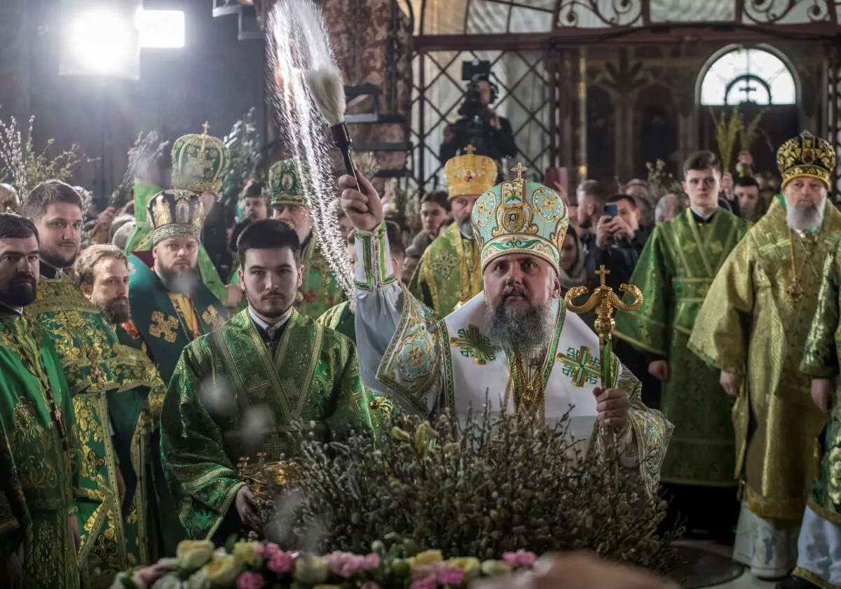 Metropolitan Epiphanius I, head of the Orthodox Church of Ukraine, sprinkles holy water on believers on April 9, 2023, after a service which marks the Orthodox feast of Palm Sunday in a church at the compound of the Kyiv Pechersk Lavra monastery in Kyiv, Ukraine, amid Russia's invasion of Ukraine. (Vladyslav Musiienko/Reuters)