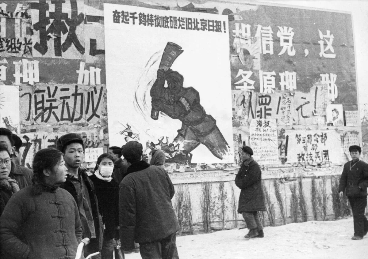 Chinese youths walk past several dazibaos, the revolutionary placards, during the Cultural Revolution in downtown Beijing in February 1967. (AFP via Getty Images)
