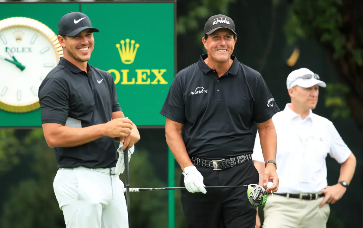 Brooks Koepka of the United States and Phil Mickelson of the United States talk on the tenth tee during the final round of the BMW Championship at Medinah Country Club No. 3 in Medinah, Ill., on August 18, 2019. (Andrew Redington/Getty Images)