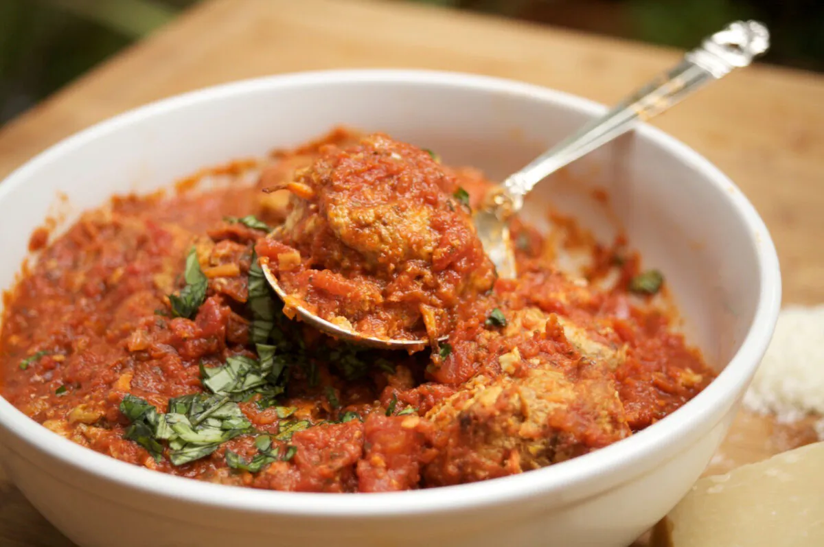 A simple tomato sauce spruced up with capers and olives give these airy, fluffy meatballs an Italian touch. (Courtesy of Diane Rossen Worthington)