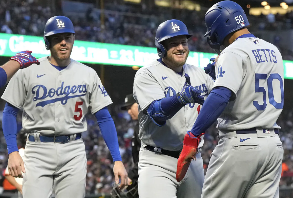 Max Muncy (13) of the Los Angeles Dodgers is congratulated by Mookie Betts (50) and Freddie Freeman (5) after hitting a three-run home run against the San Francisco Giants in the top of the third inning in San Francisco on April 10, 2023. (Thearon W. Henderson/Getty Images)