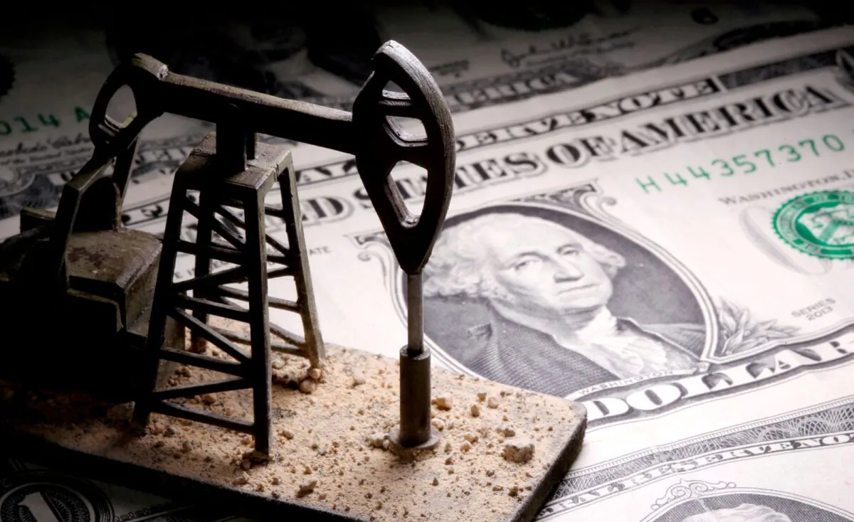 A 3D printed oil pump jack is placed on dollar banknotes in this illustration picture, on April 14, 2020. (Dado Ruvic/Reuters)