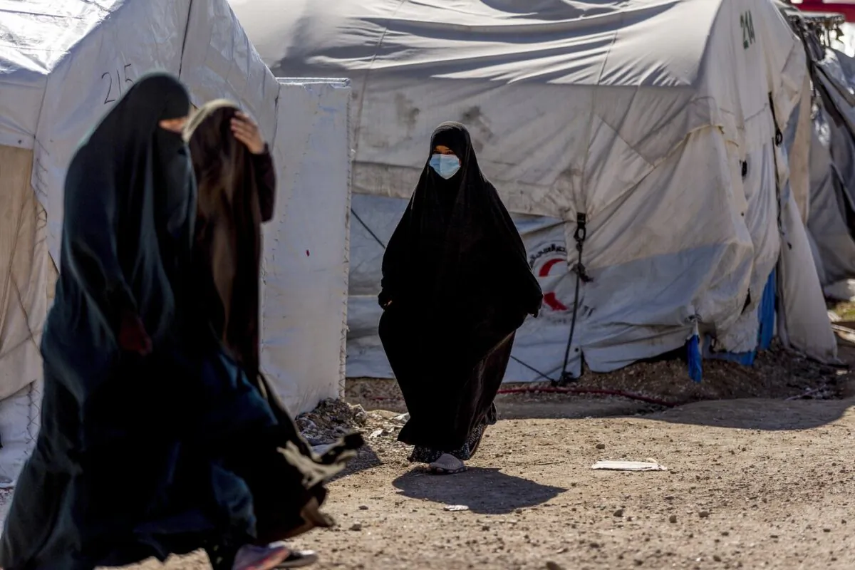 Women walk in Roj detention camp in northeast Syria on Feb. 9, 2022. (The Associated Press/Baderkhan Ahmad)