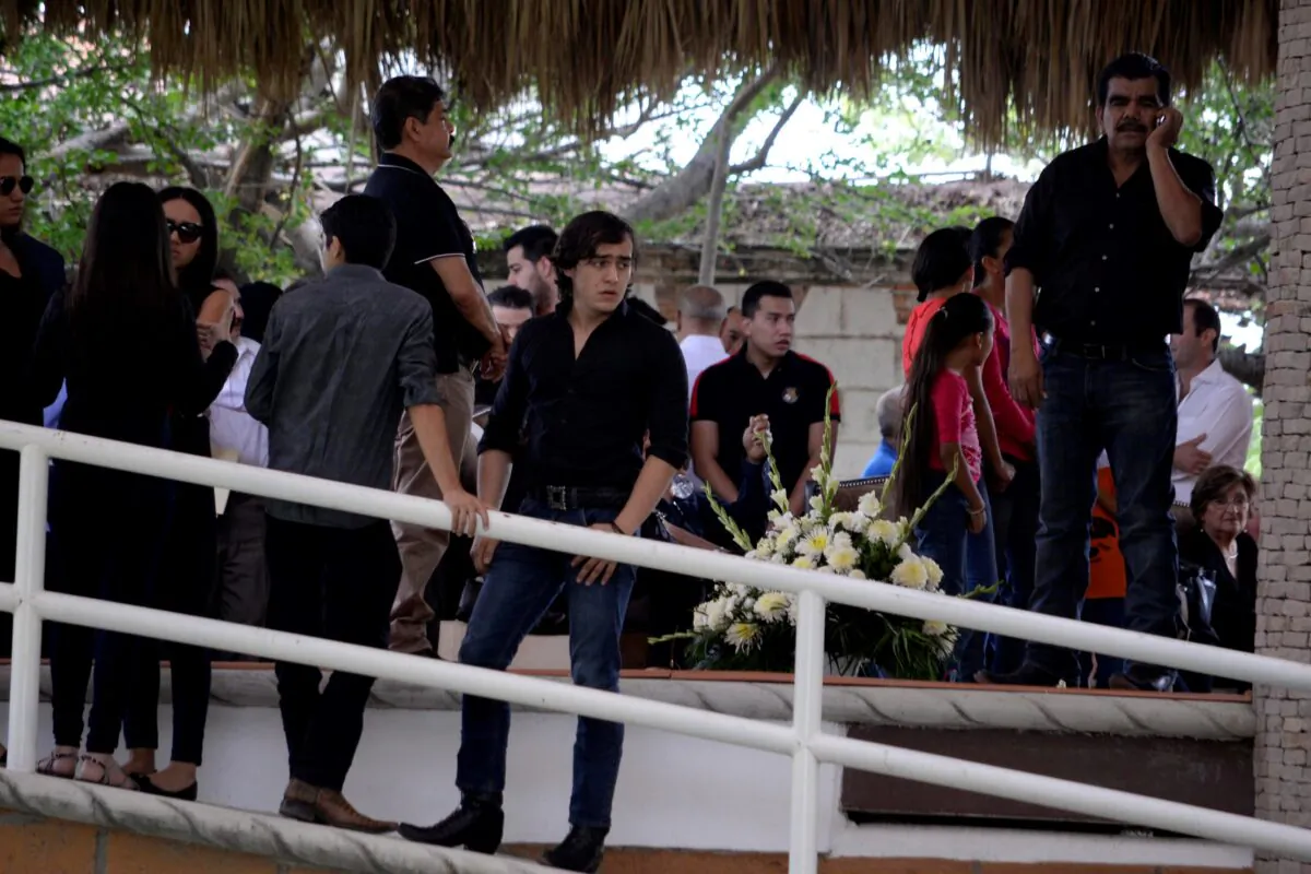 Mexican musician and actor Julian Figueroa, the son of Mexican ballad singer Joan Sebastian and singer Maribel Guardia, stands amongst guests during his father's wake at their home in Teacalco, Mexico, on July 14, 2015. (Tony Rivera/AP Photo)