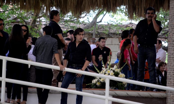 Mexican musician and actor Julian Figueroa, the son of Mexican ballad singer Joan Sebastian and singer Maribel Guardia, stands amongst guests during his father's wake at their home in Teacalco, Mexico, on July 14, 2015. (Tony Rivera/AP Photo)