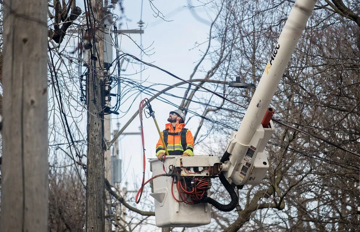 A hydro worker surveys a power line after an ice storm in Montreal, April 7, 2023. (The Canadian Press/Graham Hughes)
