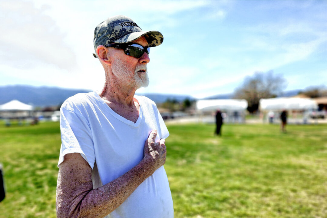 Vietnam veteran David Lucas places his hand over his heart at a ceremony in honor of Vietnam veterans in Camp Verde, Ariz., on March 29, 2023. (Allan Stein/The Epoch Times)