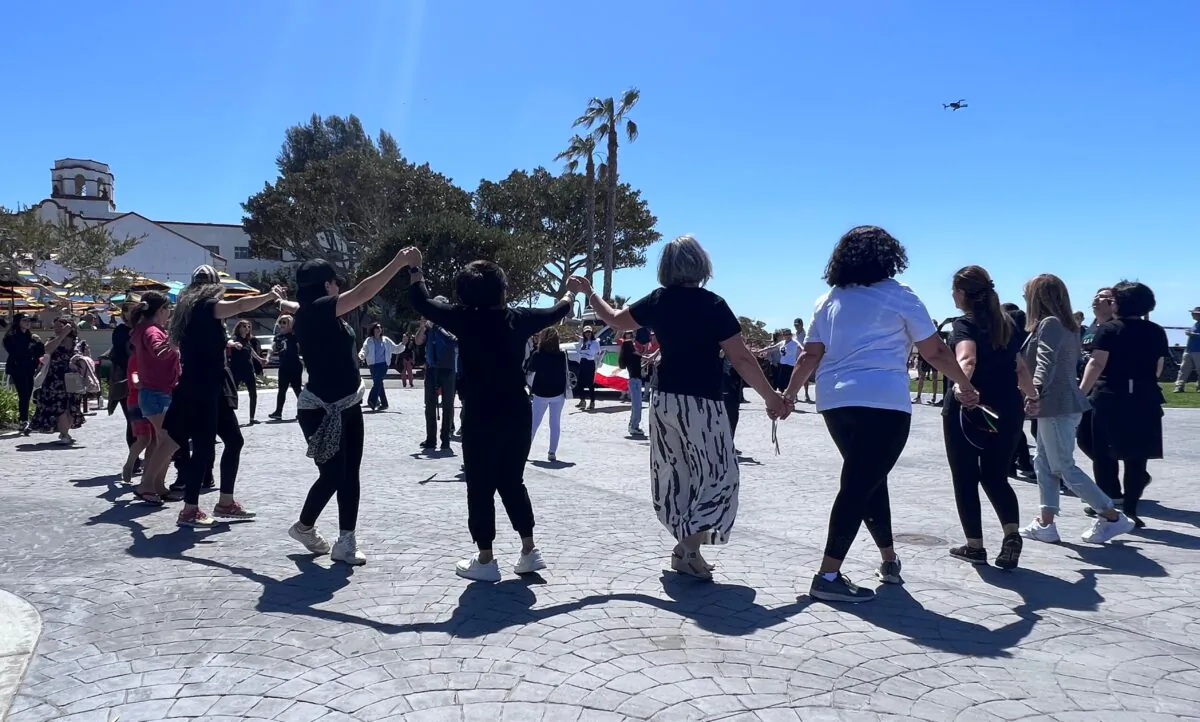 Iranian American women participate in a flash mob to raise awareness of human rights violations in Iran in Laguna Beach, California on April 8, 2023. (Rudy Blalock/The Epoch Times)
