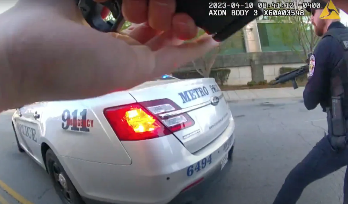 This screengrab taken from the bodycam video of Louisville Metro Police Department Officer Nickolas Wilt (L foreground) shows Officer Cory Galloway (R) with his weapon drawn as the two officers approach an active shooting situation at Old National Bank, in Louisville, Ky., on April 10, 2023.  (Louisville Metro Police Department/Screenshot via The Epoch Times)
