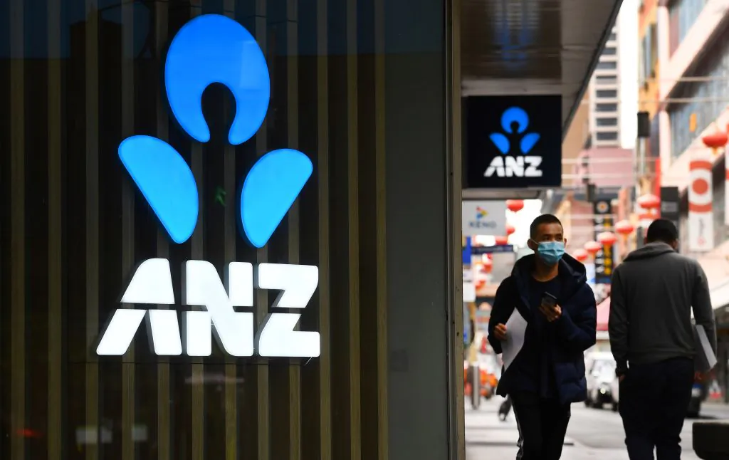 A man walks past an ANZ bank sign in Chinatown, Melbourne, on April 30, 2020. (William West/AFP via Getty Images)