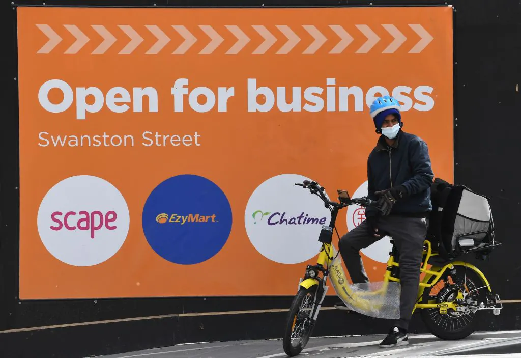 A food delivery worker waits to cross the street in Melbourne's central business district in Melbourne, Australia, on Sept. 2, 2020. (William West/AFP via Getty Images)