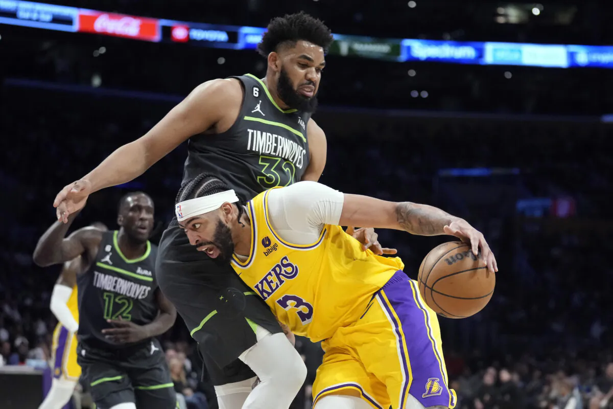 Los Angeles Lakers forward Anthony Davis (3) is defended by Minnesota Timberwolves forward Karl-Anthony Towns (32) during the first half of an NBA basketball play-in tournament game in Los Angeles on April 11, 2023. (Marcio Jose Sanchez/AP Photo)