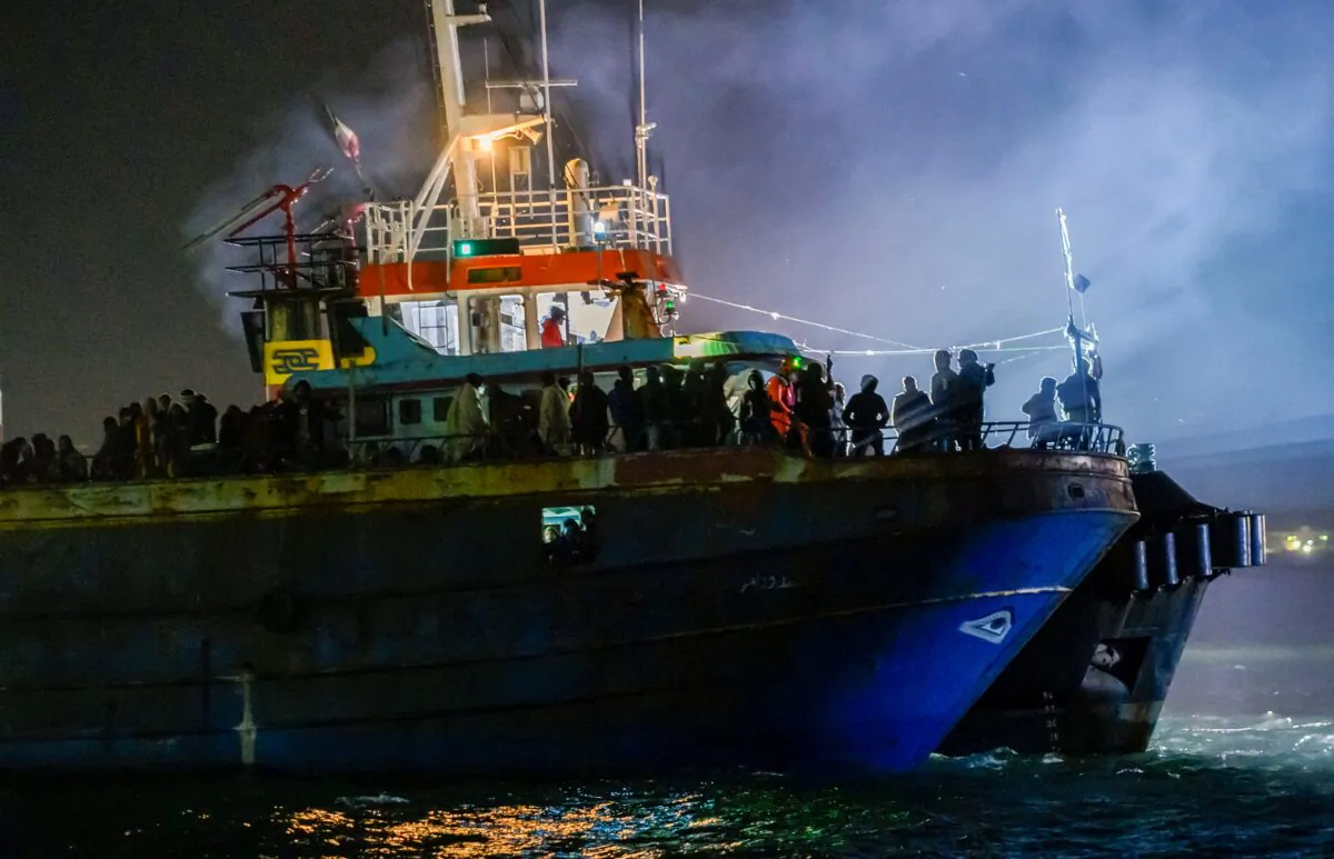 A fishing boat with some 500 migrants enters the southern Italian port of Crotone, on March 11, 2023. (Valeria Ferraro/AP Photo)