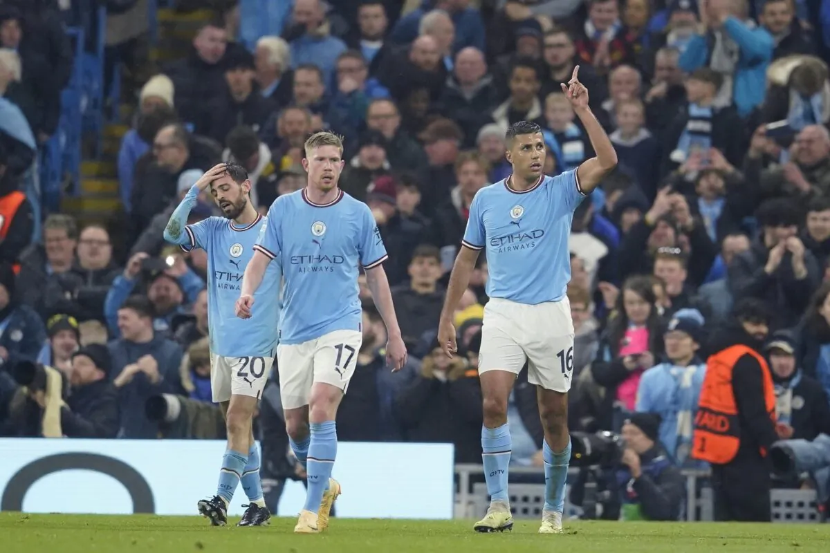 Manchester City's Rodrigo (R) celebrates after scoring the opening goal of his team during the Champions League quarterfinal, first leg, soccer match between Manchester City and Bayern Munich at the Etihad stadium in Manchester, England, on April 11, 2023. (Dave Thompson/AP Photo)