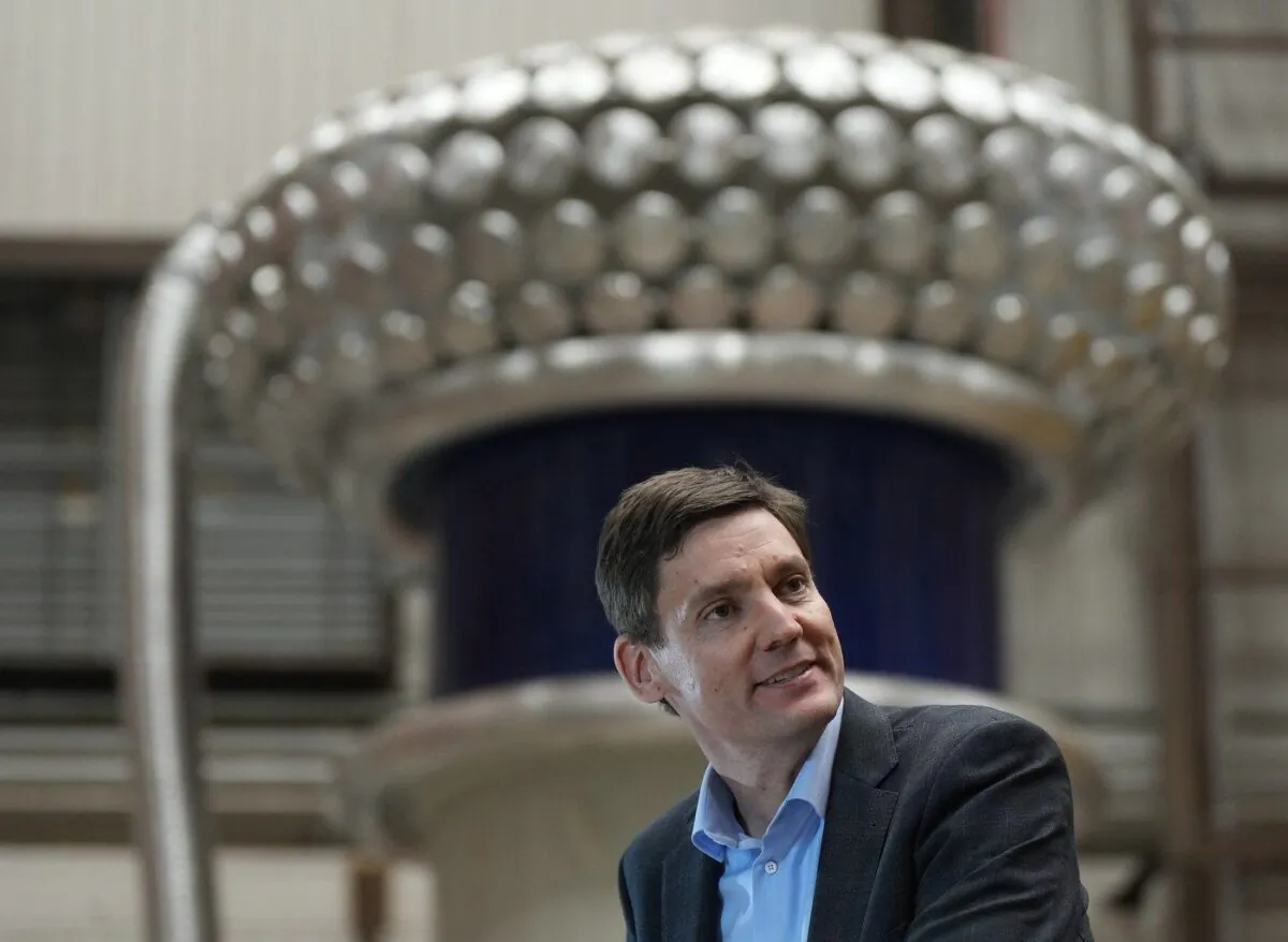 B.C. Premier David Eby speaks during a news conference as high voltage test set equipment is seen behind him at Powertech Labs, in Surrey, B.C., on Mar. 30, 2023. (The Canadian Press/Darryl Dyck)
