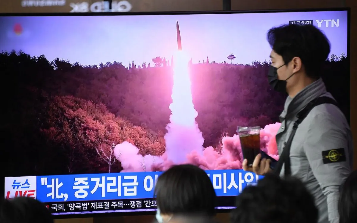 A man walks past a television screen showing a news broadcast with file footage of a North Korean missile test, at a railway station in Seoul, South Korea, on April 13, 2023. (Yung Yeon-je/AFP via Getty Images)