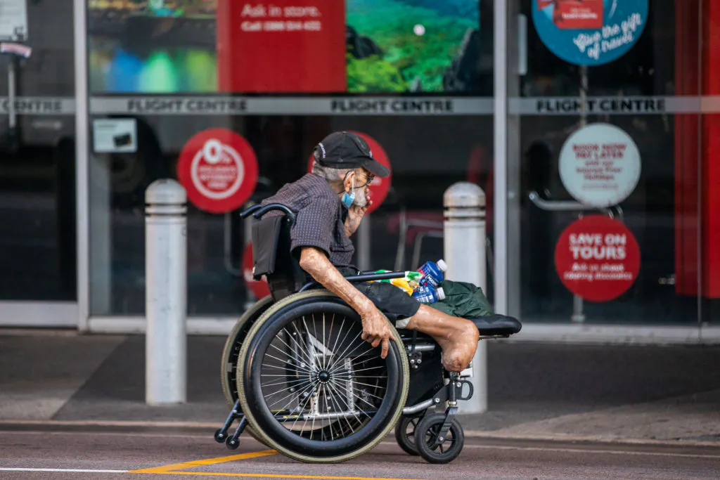 A man wheels his wheelchair along Mitchell street in Darwin, Australia, on June 30, 2021. (Helen Orr/Getty Images)