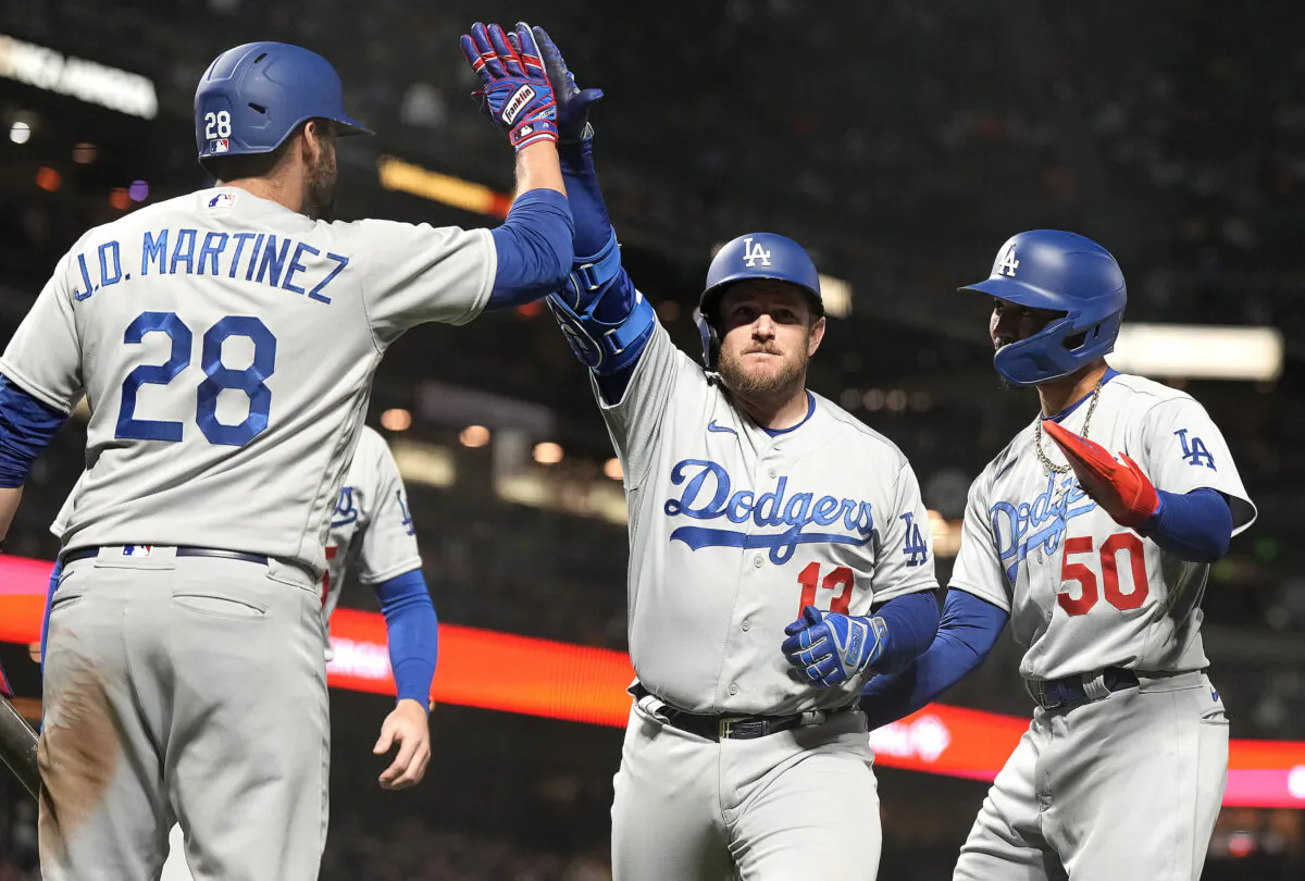 Max Muncy (13) of the Los Angeles Dodgers is congratulated by J.D. Martinez (28) and Mookie Betts (50) after Muncy hit a three-run home run against the San Francisco Giants in the top of the six inning at Oracle Park in San Francisco on April 12, 2023. (Thearon W. Henderson/Getty Images)