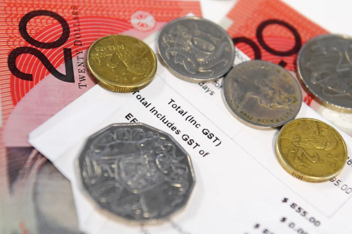 A receipt showing General Sales Tax (GST) is shown alongside Australian notes and coins in Sydney, on July 4, 2018. (AAP Image/Sam Mooy)