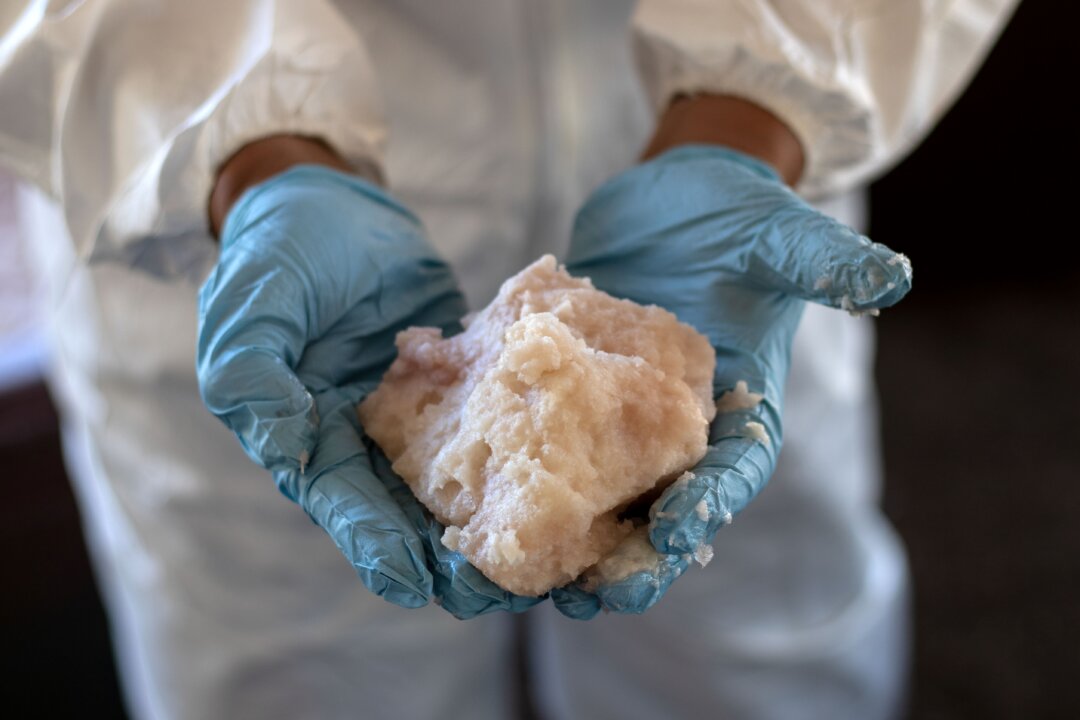 A Mexican Army expert shows crystal meth paste at a clandestine laboratory near la Rumorosa town in Tecate, Baja California state, Mexico, on Aug. 28, 2018. (Guillermo Arias/AFP via Getty Images)