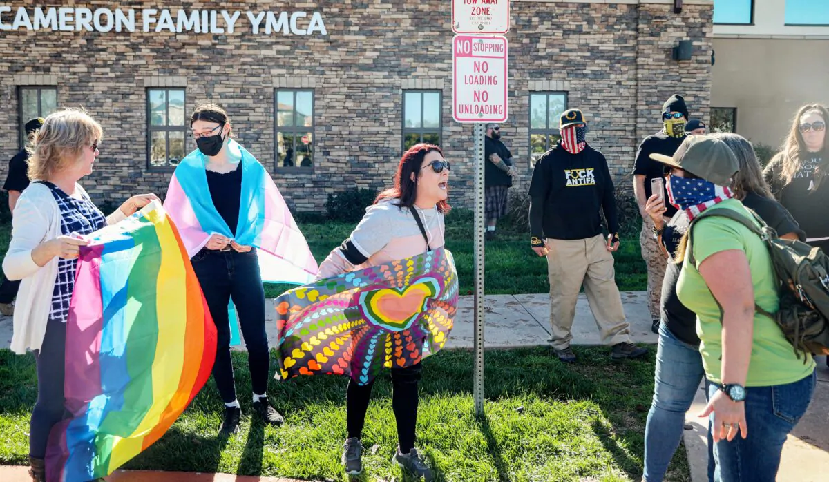 Pro-gender rights activist (L) face off against protesters rallying against Christynne Wood, a transgender woman who was criticized for using the female locker room at the YMCA, in Santee, a suburban city in San Diego County, Calif., on Jan. 21, 2023. (Sandy Huffaker/AFP via Getty Images)
